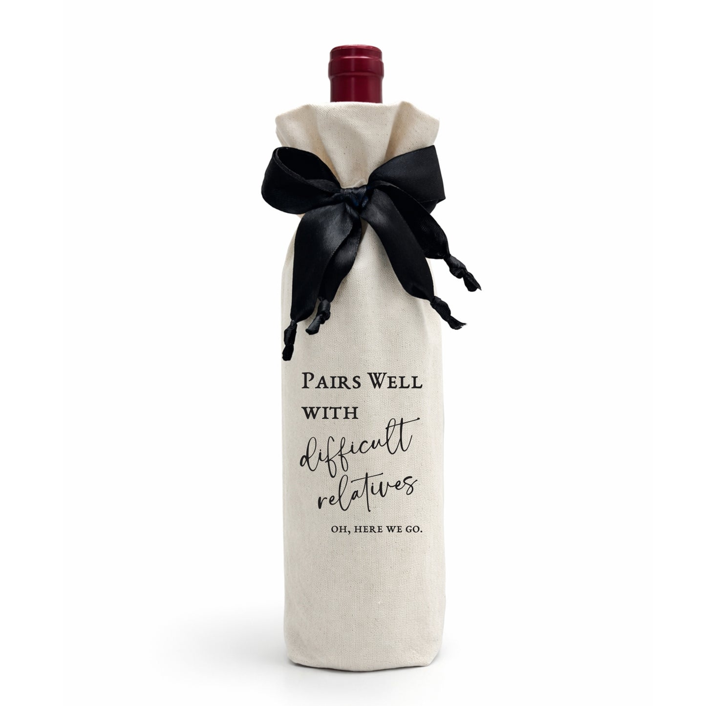 Wine bottle wrapped in a calico cotton gift bag, luxe satin ribbon with black text on a white background, Pairs Well With Difficult Relatives.
