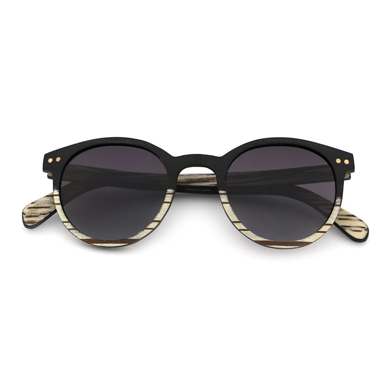 The AVELINE's round frames, crafted from ebony and white zebrawood, are perfect for small faces. Experience the elegance of a two-tone wooden frame while making a sustainable style statement.