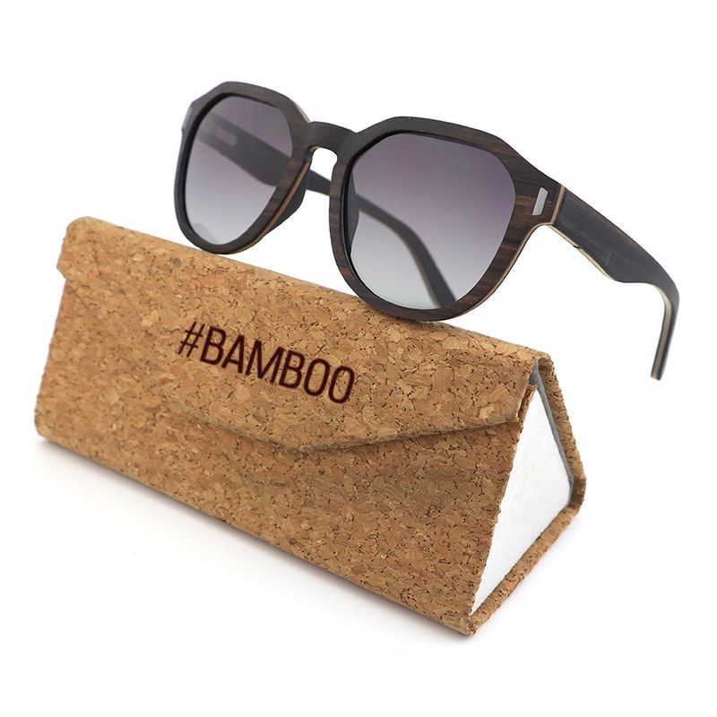 Our Hashtag Bamboo Auroras feature a round eyeglasses with a solid wood frame in ebony and maple laminate, featuring carved wood arms and spring hinges. The lenses are gradient grey polarised. Grab a branded case for a discounted R100.