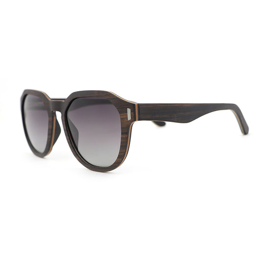 Our Hashtag Bamboo Auroras feature a round eyeglasses with a solid wood frame in ebony and maple laminate, featuring carved wood arms and spring hinges. The lenses are gradient grey polarised.
