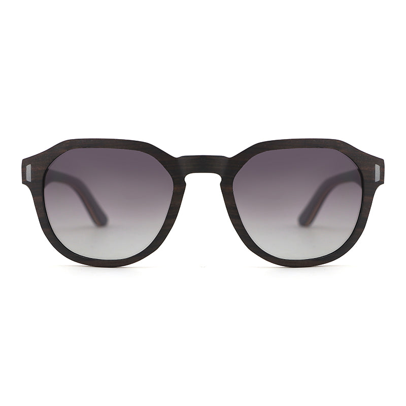 Our Hashtag Bamboo Auroras feature a round eyeglasses with a solid wood frame in ebony and maple laminate, featuring carved wood arms and spring hinges. The lenses are gradient grey polarised.