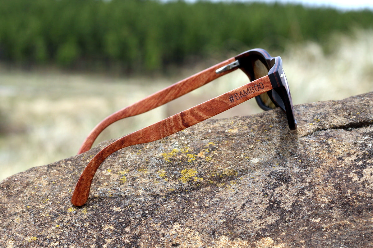 Mens solid wood ebony sunglasses with orange mirror polarised lens, includes free case valued at R120.