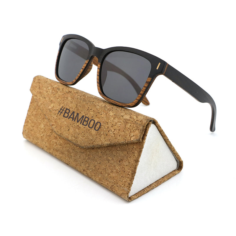 Unisex polarised wooden sunglasses crafted from ebony and zebrawood, shown on Hashtag Bamboo's branded cork case.