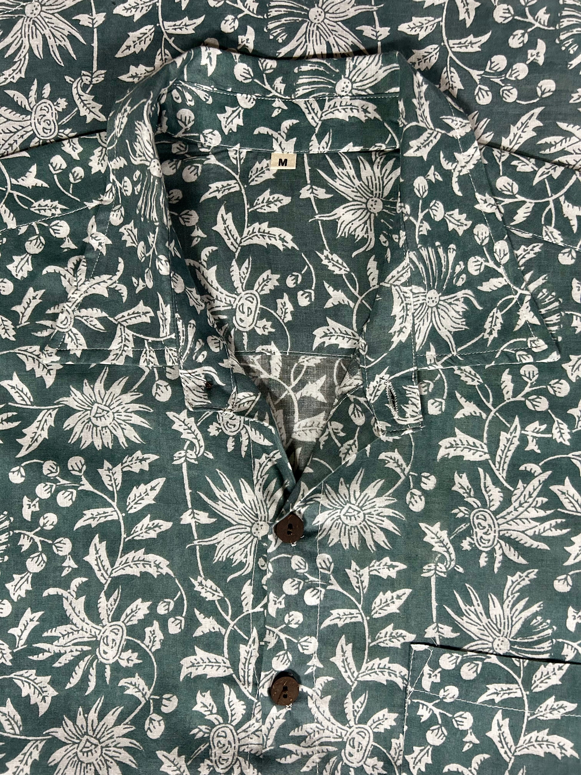Close-up of a shirt with a floral pattern on a dark green background