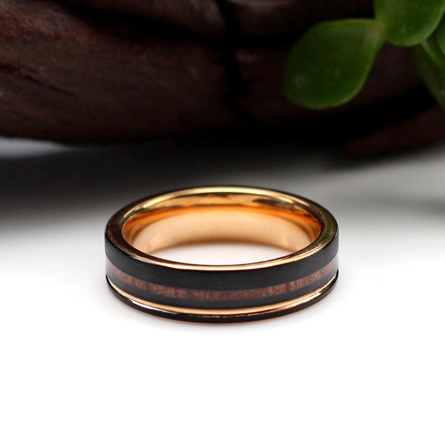 Men's black tungsten 6mm ring with wood inlay and rose gold band. Hashtag Bamboo, orbit rings, NYJ we've got them covered.