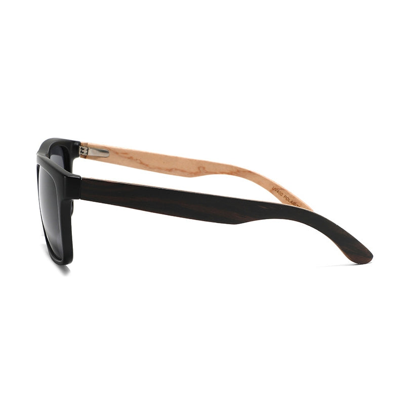 A pair of sunglasses with a glossy black acetate frame and natural light brown bamboo wood temples, shown from a side profile on a white background.