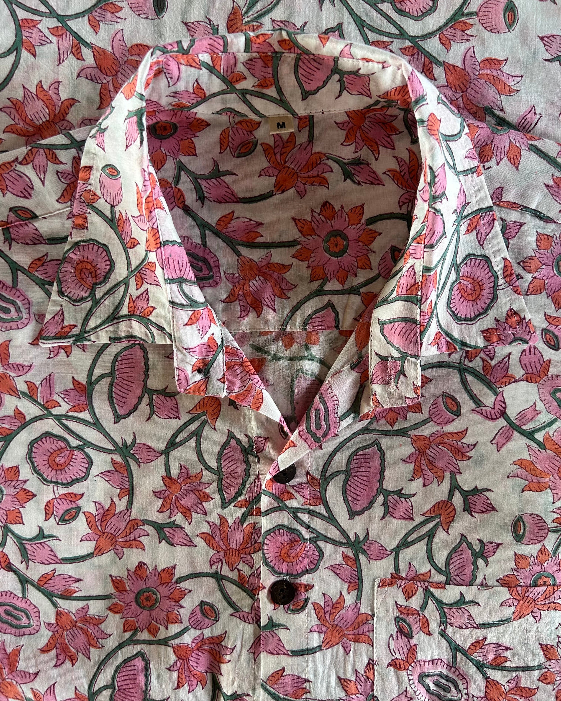 Floral patterned fabric with a collar on a matching floral background
