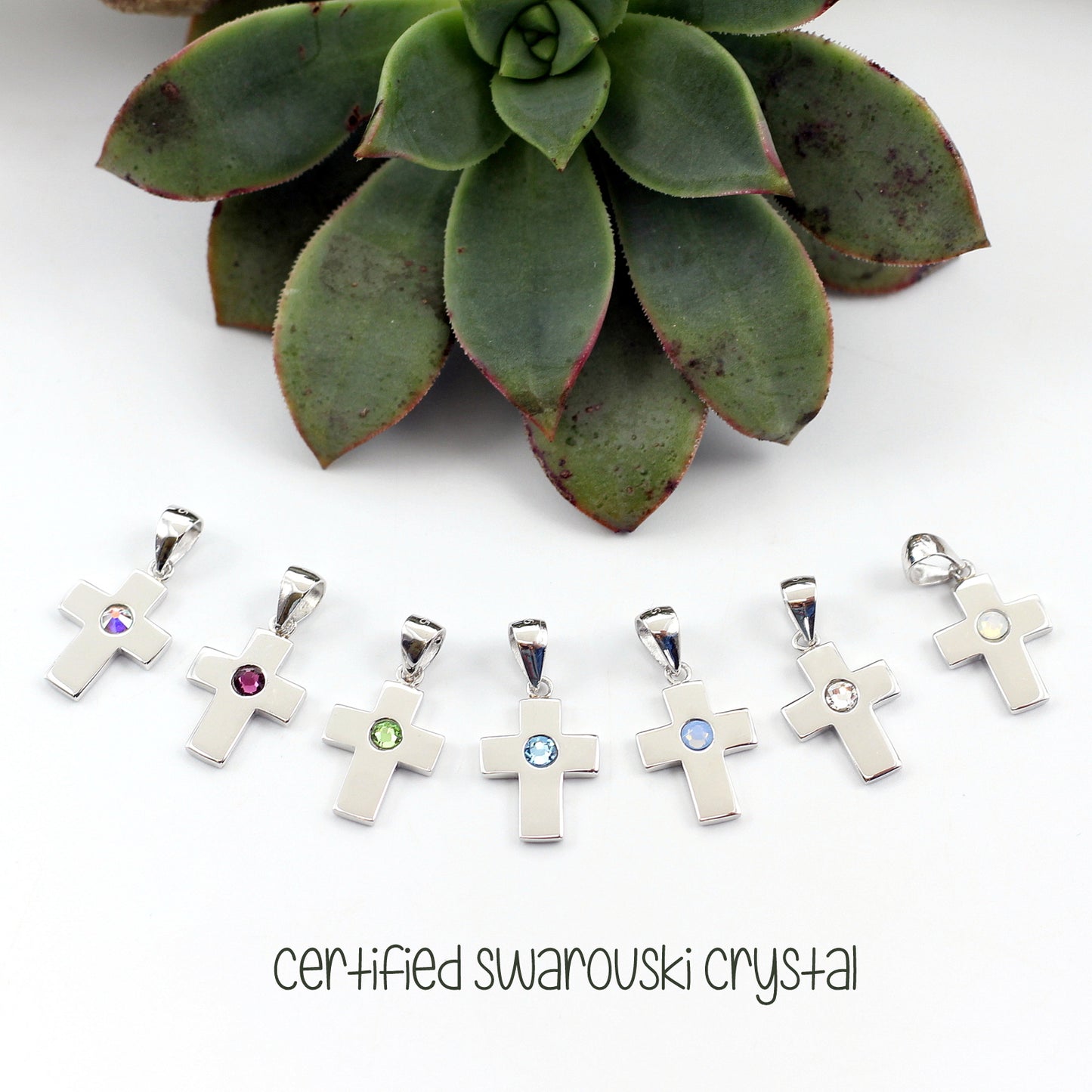 925 sterling silver cross on chain, swarovski stone, available in 7 colours. Overnight courier to main centres.