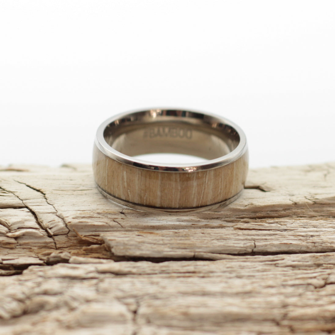 Mens wedding band, titanium ring with wild olive inlay, hashtag bamboo, orbit.