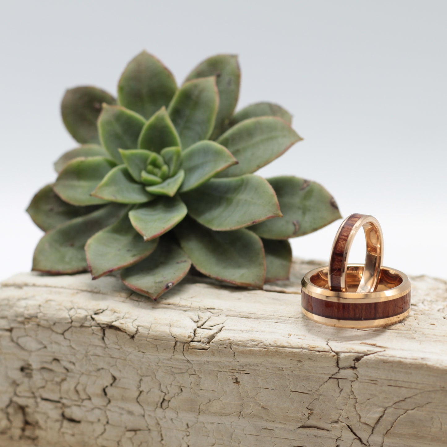 Matching rosegold tungsten rings with koa wood inlay, 8mm band for him and a dainty 4mm band for her.  Available in sizes 6-15.